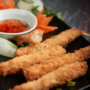 Deep Fried Breaded Shrimps on a Black Plate