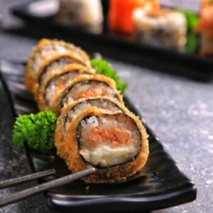 Delicious crispy sushi roll served neatly on a plate with chopsticks.
